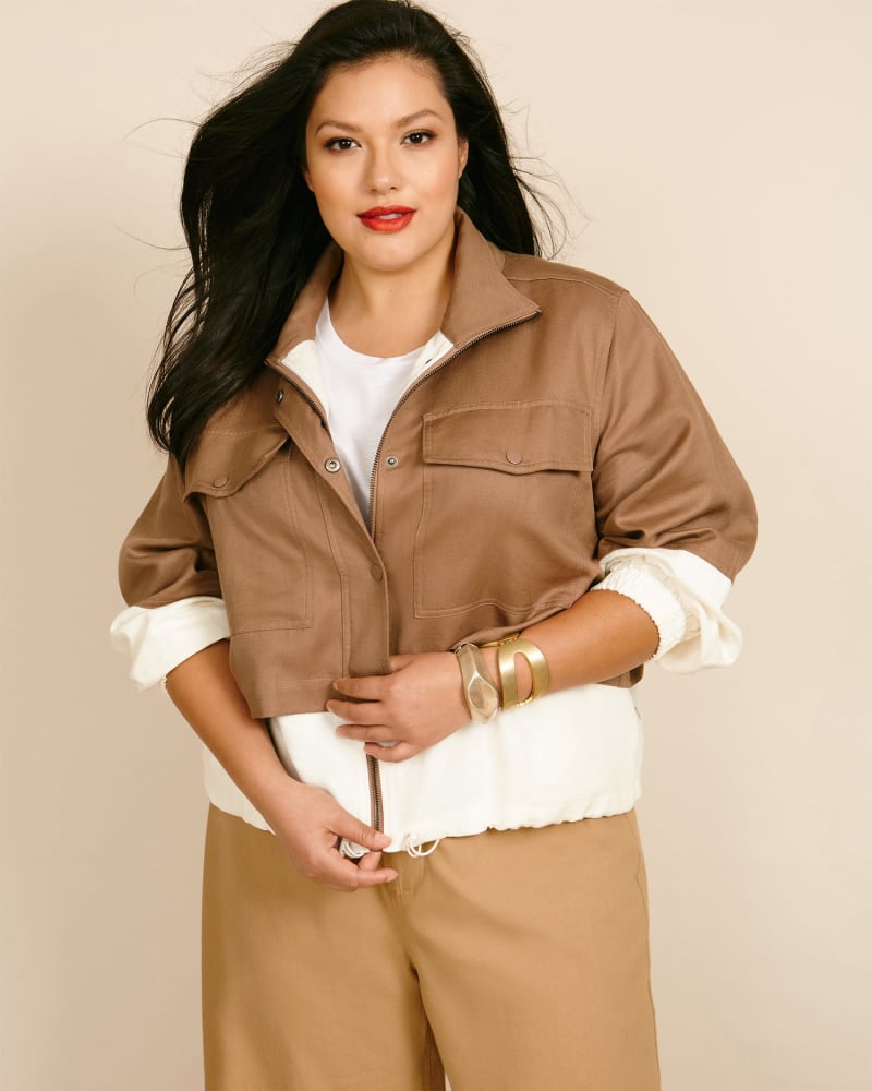 Front of a model wearing a size 2XL Selva Cropped Windbreaker in Camel by Apiece Apart. | dia_product_style_image_id:226731